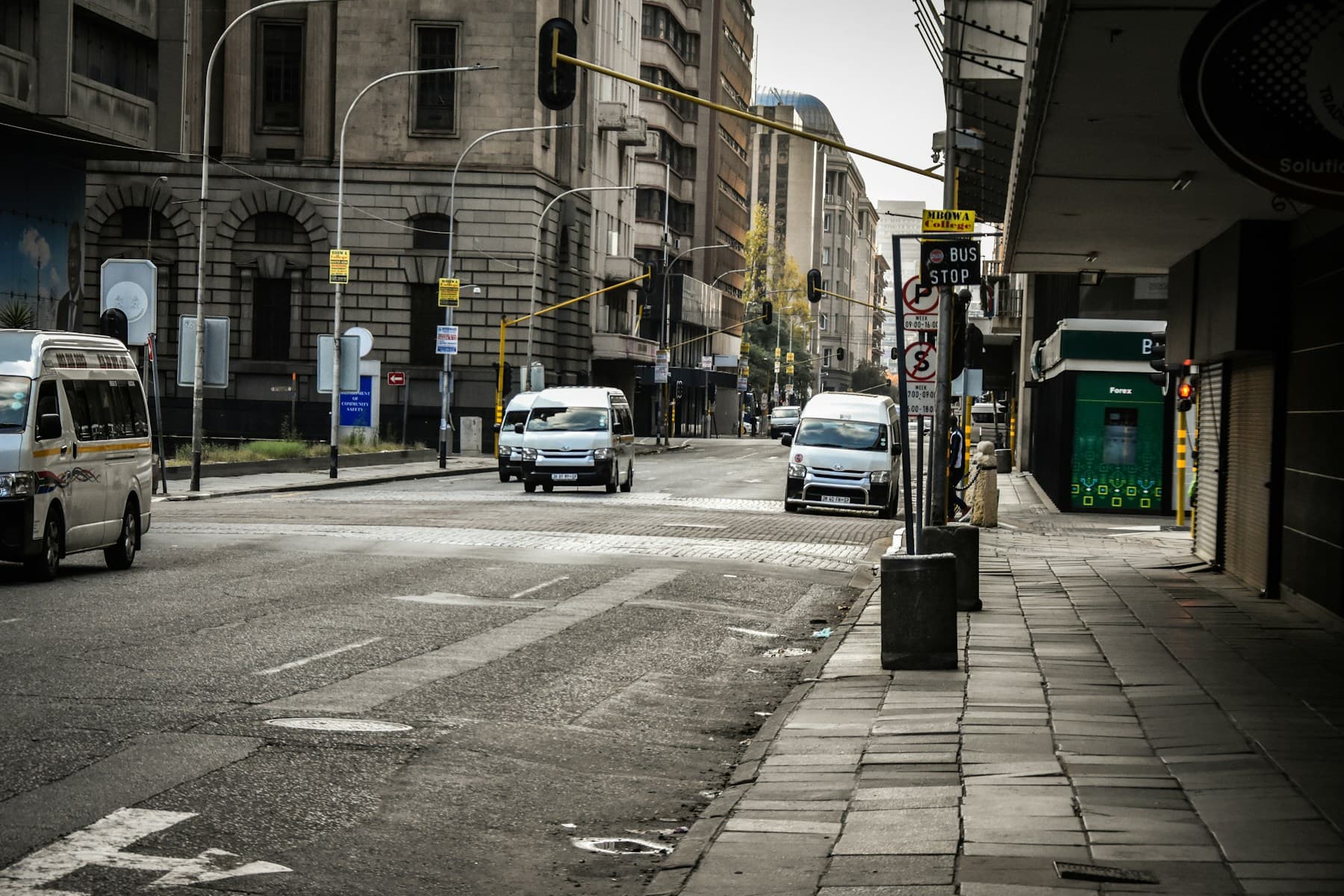 Johannesburg street with minibus taxis, vehicles, and city buildings